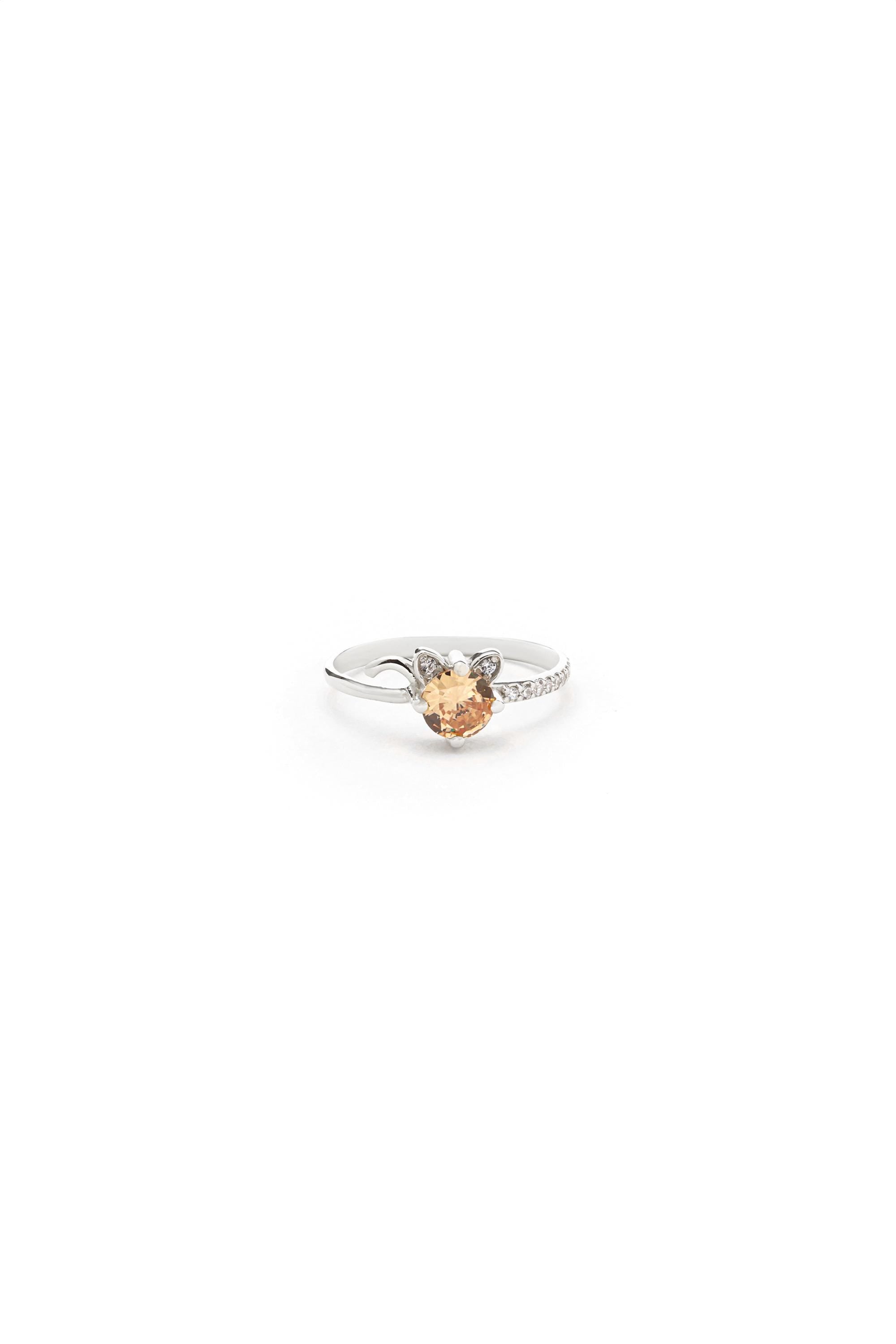 A silver ring with a small, colorful gemstone in the center.