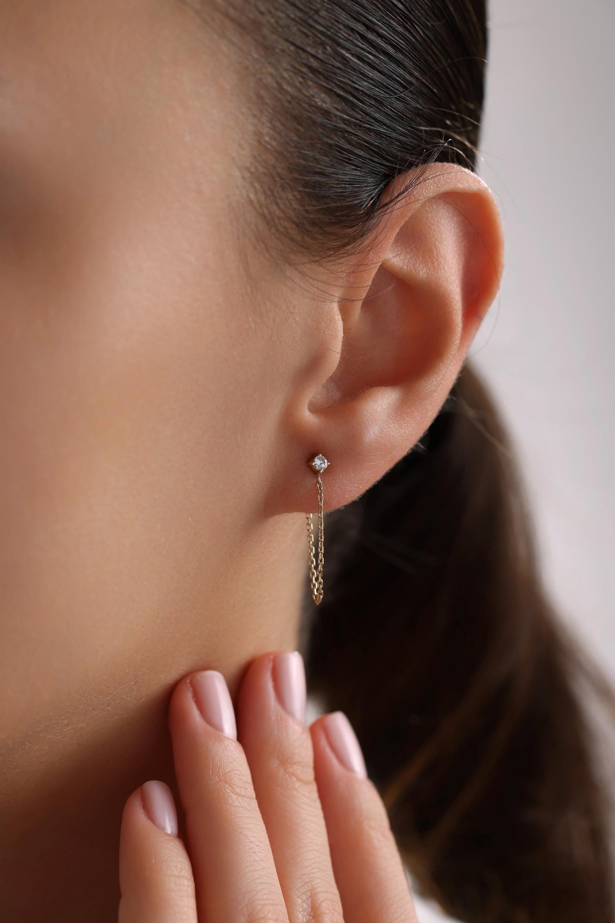 May include: A pair of gold chain earrings with a small diamond stud at the top of each chain.